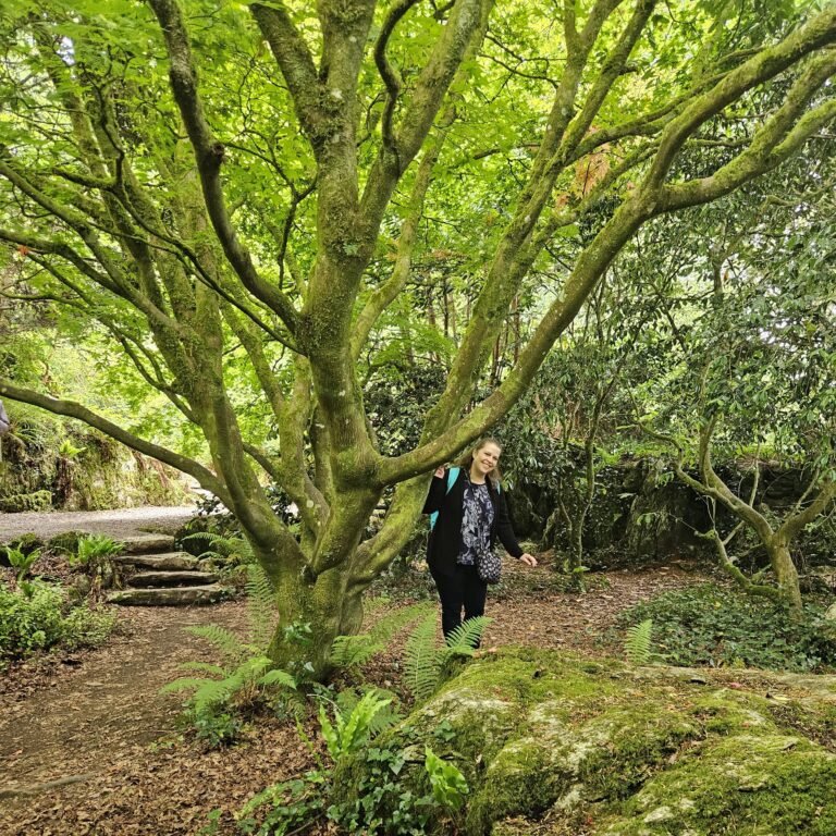 Author by a moss-covered tree on the grounds of Blarney Castle, Ireland.